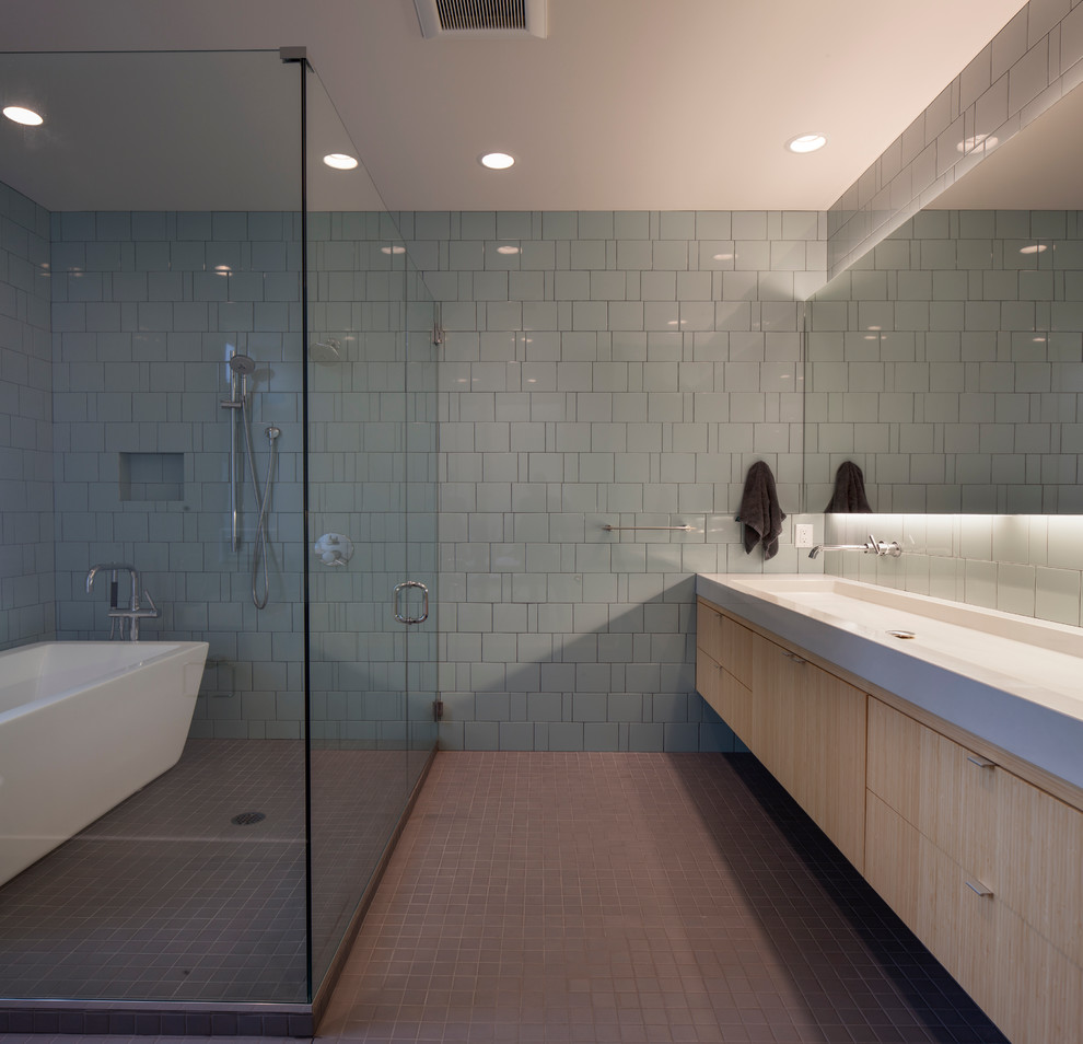 Inspiration for a mid-sized modern master gray tile and glass tile porcelain tile bathroom remodel in Seattle with flat-panel cabinets, light wood cabinets, a two-piece toilet, a trough sink, quartz countertops and blue walls