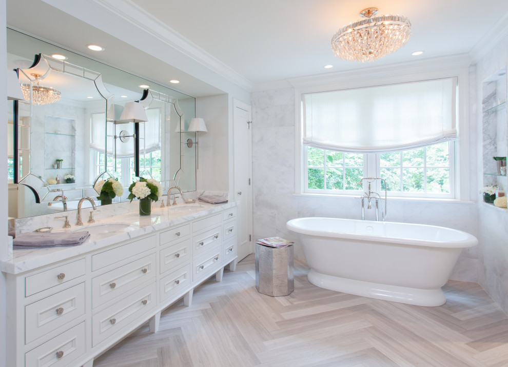 Freestanding bathtub - large transitional master white tile and porcelain tile beige floor freestanding bathtub idea in Philadelphia with recessed-panel cabinets, white cabinets, an undermount sink and white countertops