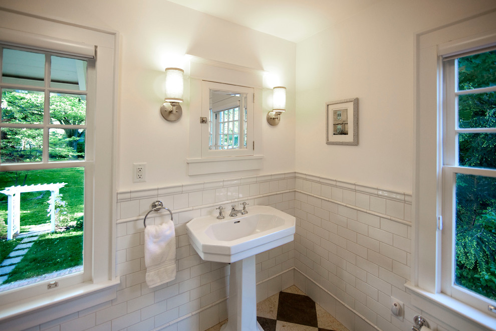 Small elegant 3/4 white tile and ceramic tile slate floor bathroom photo in New York with white walls, a wall-mount sink and solid surface countertops