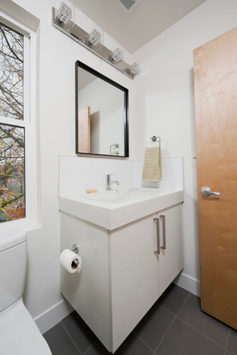 Small urban 3/4 white tile and ceramic tile ceramic tile freestanding bathtub photo in Denver with a drop-in sink, flat-panel cabinets, white cabinets, concrete countertops and white walls
