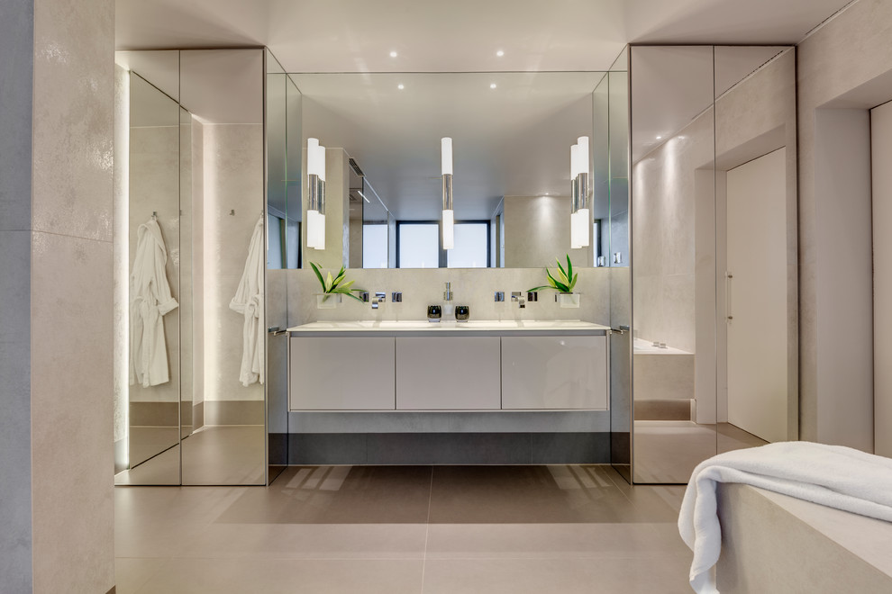 Design ideas for a large contemporary ensuite bathroom in Devon with a built-in bath, beige walls, porcelain flooring, beige floors, flat-panel cabinets and white cabinets.