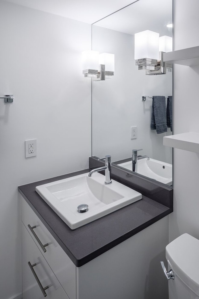 Small contemporary shower room bathroom in Ottawa with a built-in sink, a sliding door, grey cabinets, white tiles, ceramic tiles, white walls, porcelain flooring, quartz worktops and grey floors.