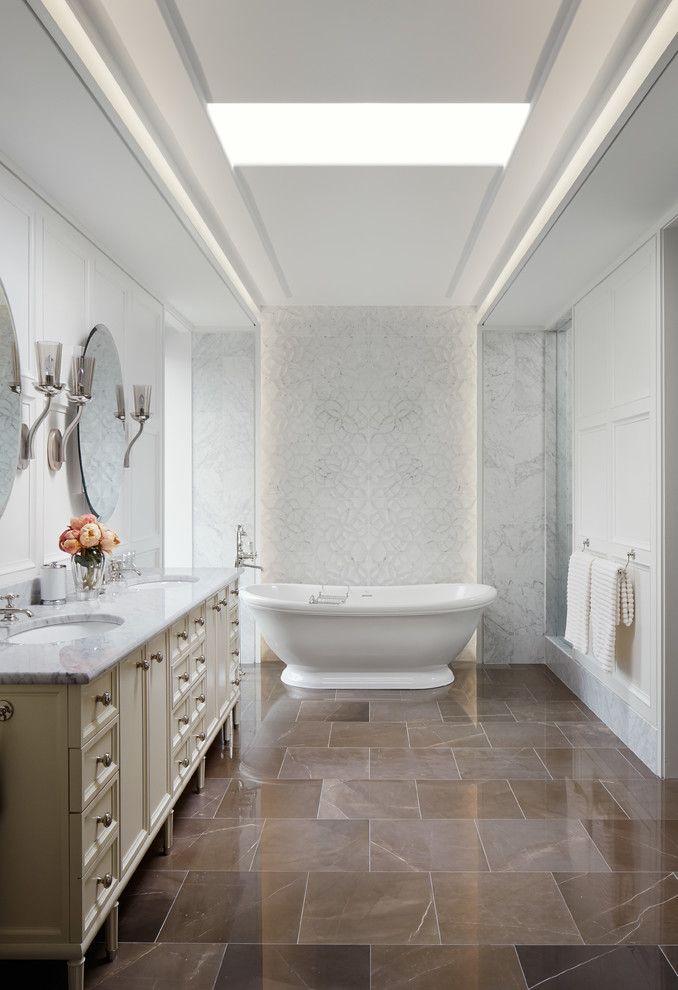 Inspiration for an expansive traditional ensuite bathroom in Chicago with beige cabinets, a freestanding bath, an alcove shower, marble flooring, solid surface worktops, a submerged sink, white tiles, white walls and recessed-panel cabinets.