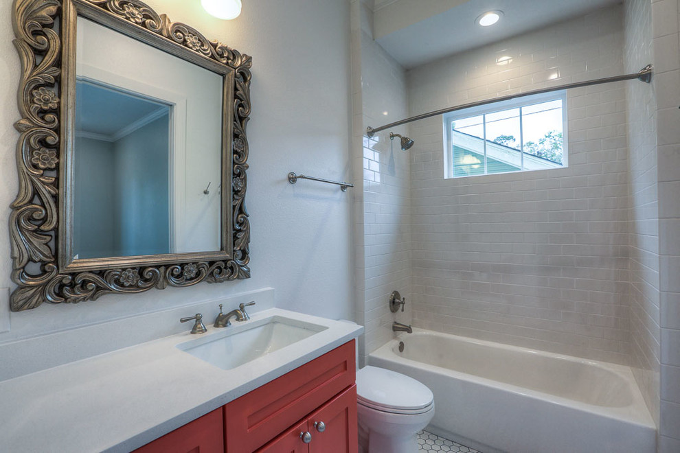 This is an example of a medium sized traditional shower room bathroom in Orange County with shaker cabinets, red cabinets, an alcove bath, a shower/bath combination, a one-piece toilet, white tiles, metro tiles, white walls, mosaic tile flooring, a submerged sink and engineered stone worktops.