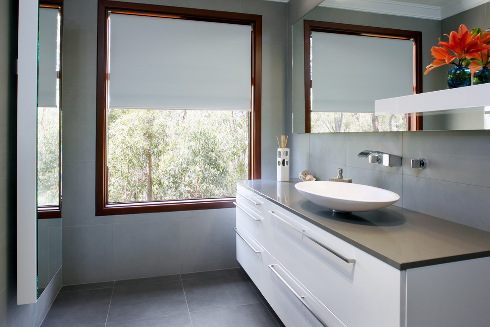 Photo of a large contemporary ensuite bathroom in Perth with white cabinets, engineered stone worktops, a freestanding bath, a walk-in shower, grey tiles, ceramic tiles, grey walls and ceramic flooring.