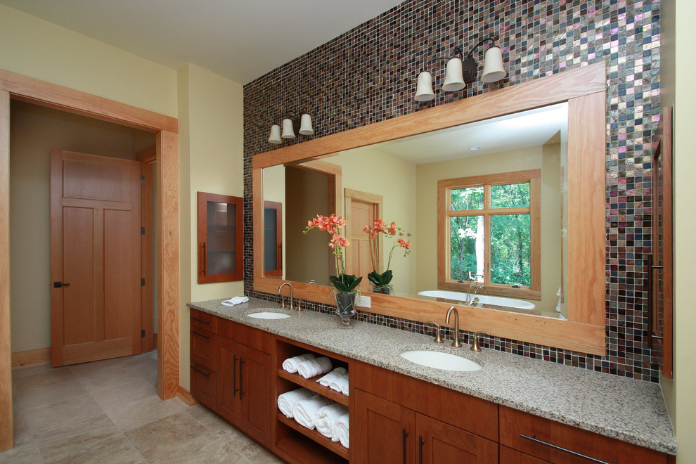 Exempel på ett modernt en-suite badrum, med ett undermonterad handfat, släta luckor, skåp i mellenmörkt trä, granitbänkskiva, ett fristående badkar, flerfärgad kakel, keramikplattor, beige väggar och travertin golv