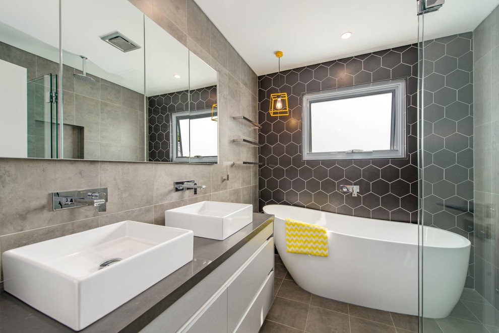 Inspiration for a medium sized contemporary ensuite bathroom in Sydney with open cabinets, grey cabinets, a freestanding bath, a walk-in shower, grey tiles, ceramic tiles, black walls, ceramic flooring, a built-in sink and quartz worktops.