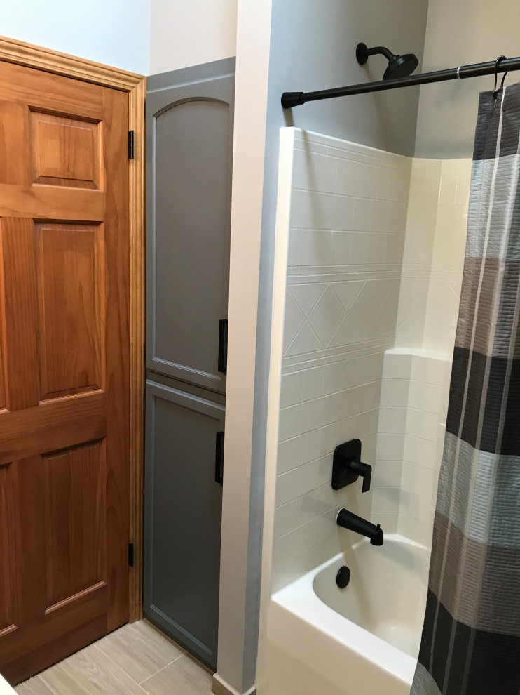 Medium sized classic family bathroom in Milwaukee with shaker cabinets, grey cabinets, an alcove bath, an alcove shower, a two-piece toilet, blue walls, porcelain flooring, a submerged sink, engineered stone worktops, beige floors, a shower curtain, beige worktops, a single sink, a built in vanity unit and a vaulted ceiling.