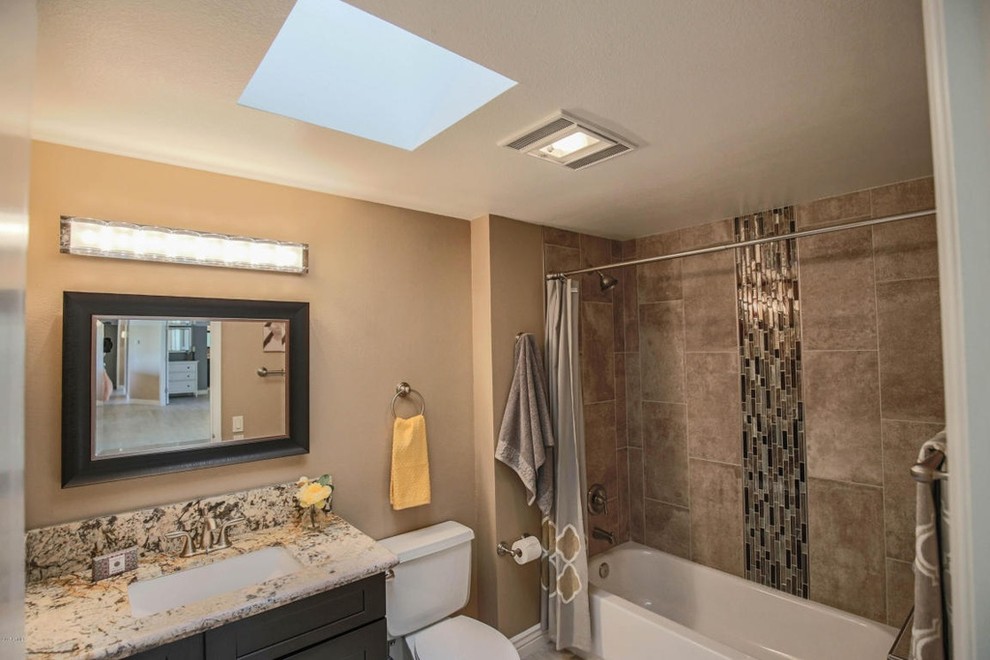 Photo of a large contemporary ensuite bathroom in Phoenix with shaker cabinets, dark wood cabinets, a corner shower, a wall mounted toilet, beige tiles, stone slabs, beige walls, ceramic flooring, a submerged sink and granite worktops.