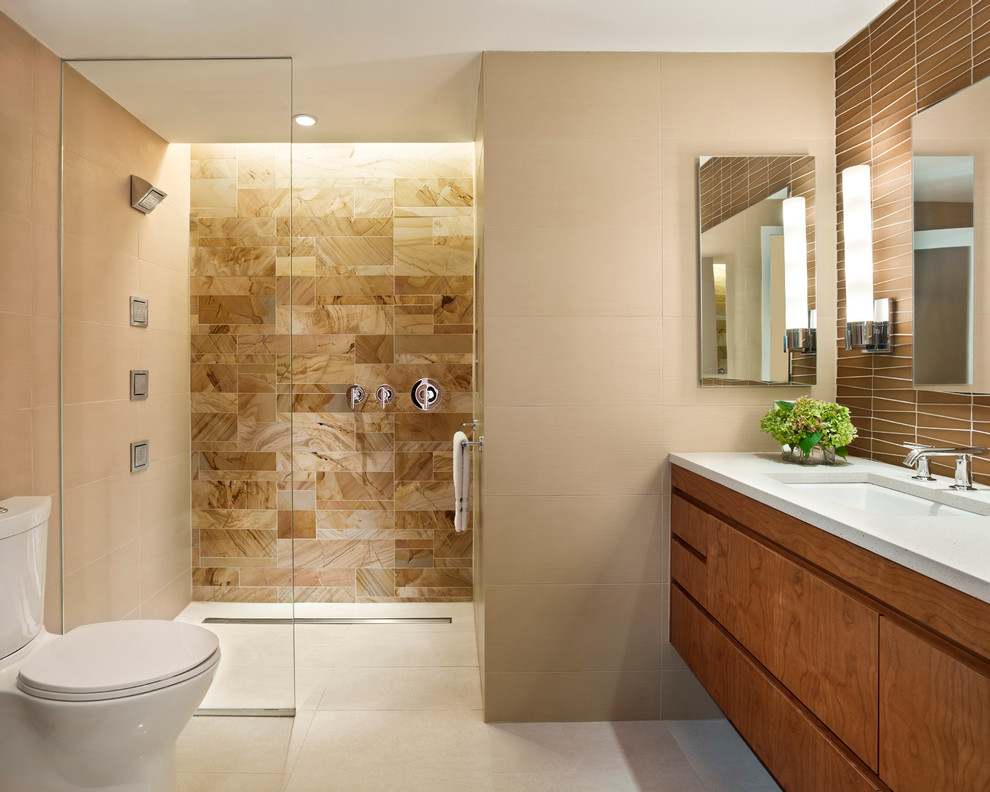 Example of a trendy beige tile and stone tile porcelain tile and beige floor walk-in shower design in Philadelphia with an undermount sink, flat-panel cabinets, medium tone wood cabinets, beige walls and white countertops