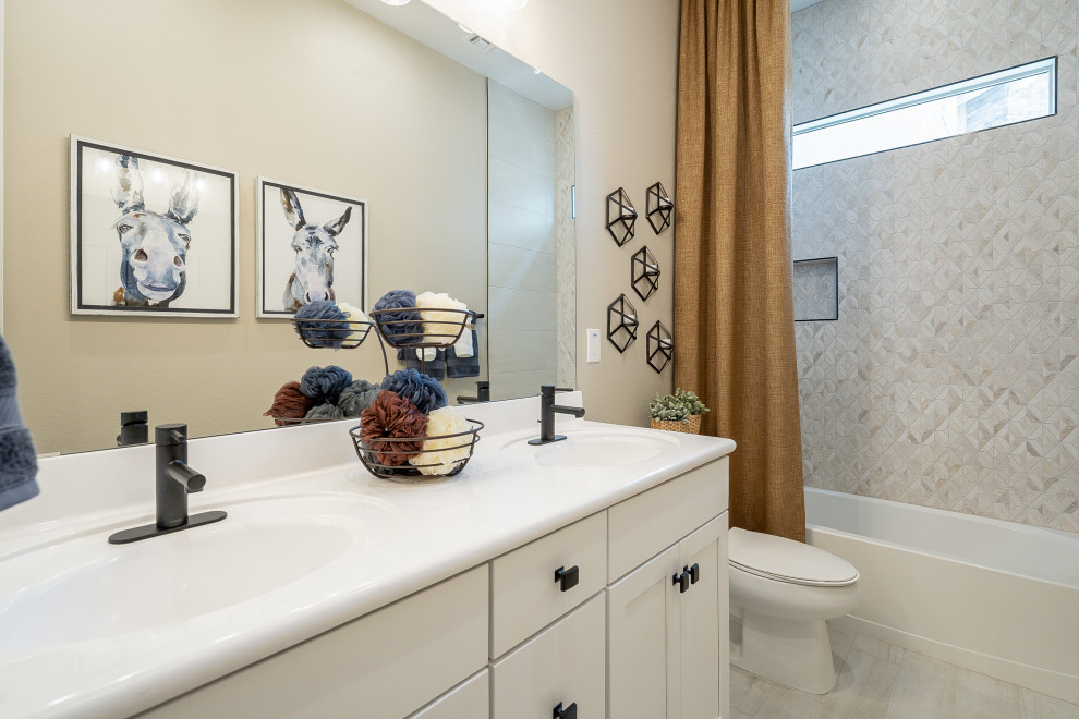 Bathroom - mid-sized contemporary kids' beige tile and ceramic tile light wood floor, beige floor and double-sink bathroom idea in Phoenix with recessed-panel cabinets, beige cabinets, beige walls, an integrated sink, solid surface countertops and white countertops