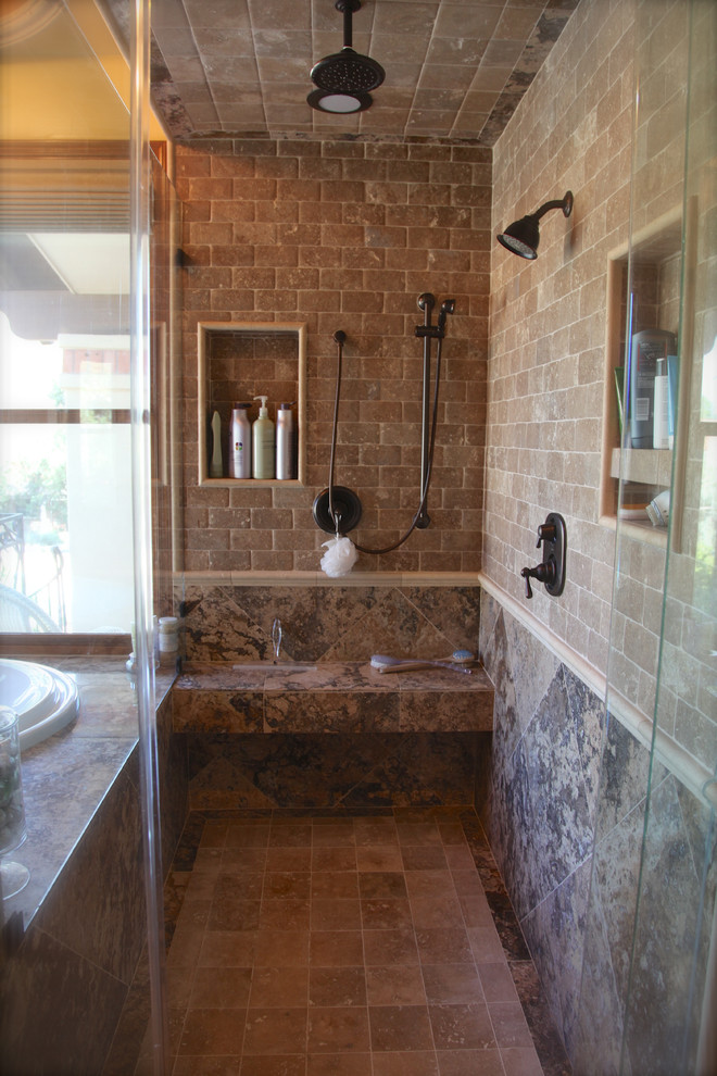 Exemple d'une grande douche en alcôve principale chic en bois foncé avec un lavabo encastré, un placard à porte affleurante, un plan de toilette en calcaire, une baignoire posée, un carrelage beige, un carrelage de pierre, un mur jaune et un sol en calcaire.