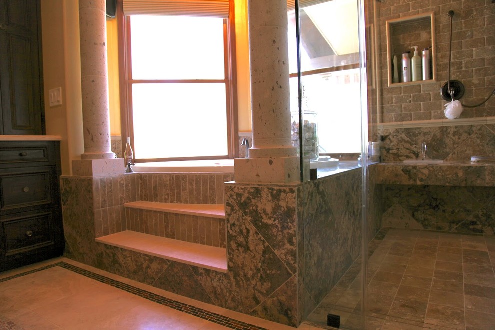 This is an example of a large classic ensuite bathroom in Phoenix with a submerged sink, beaded cabinets, dark wood cabinets, limestone worktops, a built-in bath, an alcove shower, beige tiles, stone tiles, yellow walls and limestone flooring.