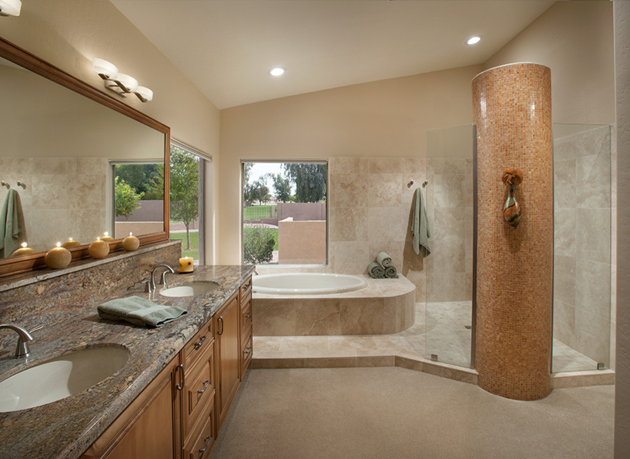 Large modern ensuite bathroom in Phoenix with a submerged sink, medium wood cabinets, a corner bath, a corner shower, beige walls, beaded cabinets, granite worktops, beige tiles, stone tiles and travertine flooring.
