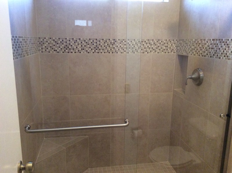 Example of a mid-sized classic beige tile and glass tile alcove shower design in Phoenix
