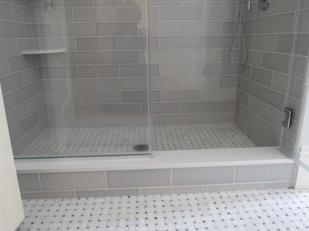 Photo detail of shower curb and flooring material. Transitional