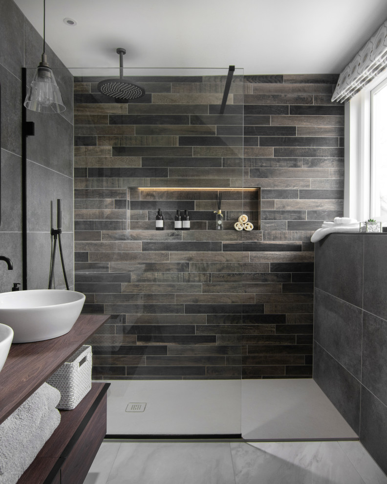 Photo of a medium sized contemporary shower room bathroom in Other with open cabinets, medium wood cabinets, an alcove shower, grey tiles, porcelain tiles, porcelain flooring, a vessel sink, wooden worktops, grey floors, brown worktops, a wall niche, double sinks and a floating vanity unit.