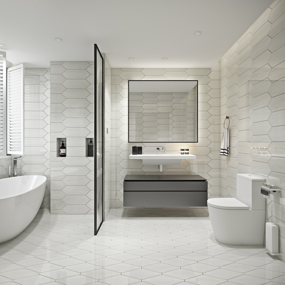 Idéer för ett stort modernt en-suite badrum, med släta luckor, bruna skåp, ett fristående badkar, en dusch/badkar-kombination, en vägghängd toalettstol, vit kakel, marmorkakel, vita väggar, marmorgolv, ett integrerad handfat, vitt golv och med dusch som är öppen