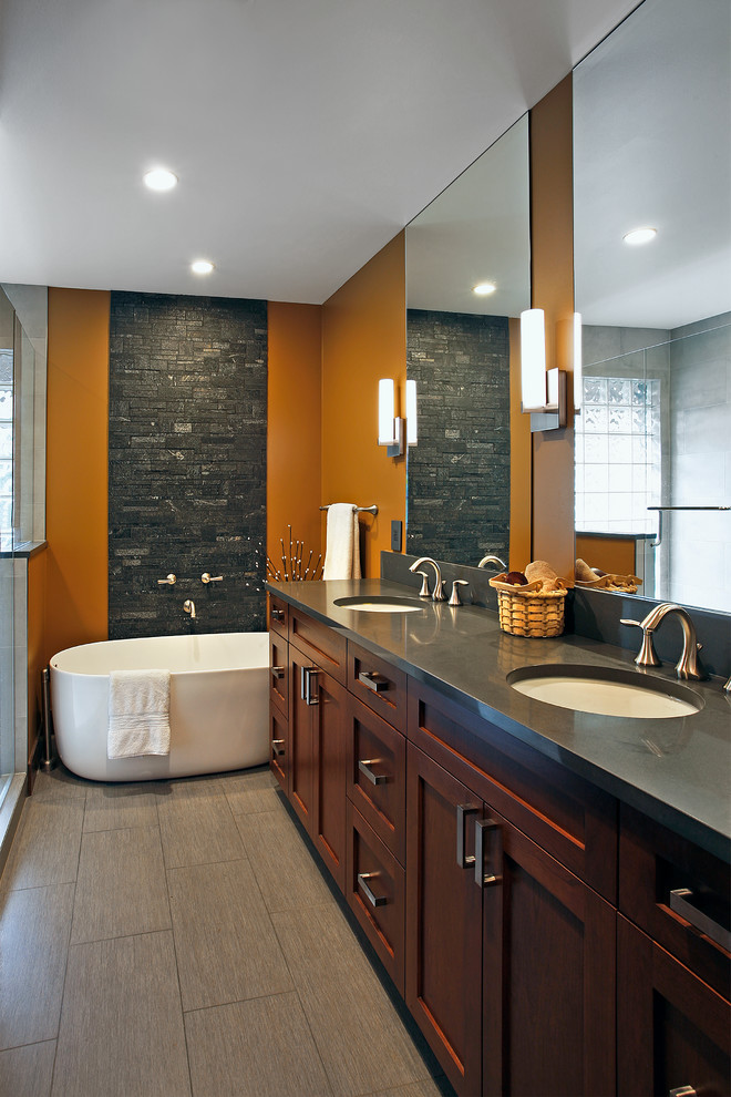 Design ideas for a medium sized classic ensuite bathroom in Seattle with shaker cabinets, medium wood cabinets, a freestanding bath, grey tiles, stone tiles, brown walls, ceramic flooring, a submerged sink and soapstone worktops.