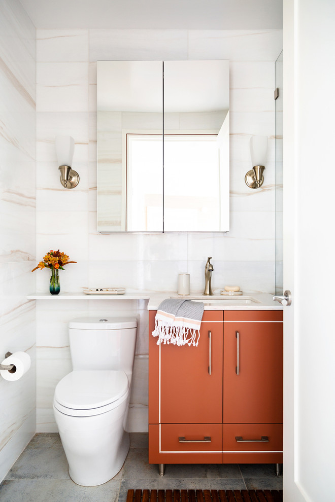 ニューヨークにあるラグジュアリーな小さなトランジショナルスタイルのおしゃれな浴室 (白いタイル、大理石タイル、白い壁、磁器タイルの床、青い床、開き戸のシャワー、白い洗面カウンター、フラットパネル扉のキャビネット、オレンジのキャビネット、アンダーカウンター洗面器) の写真