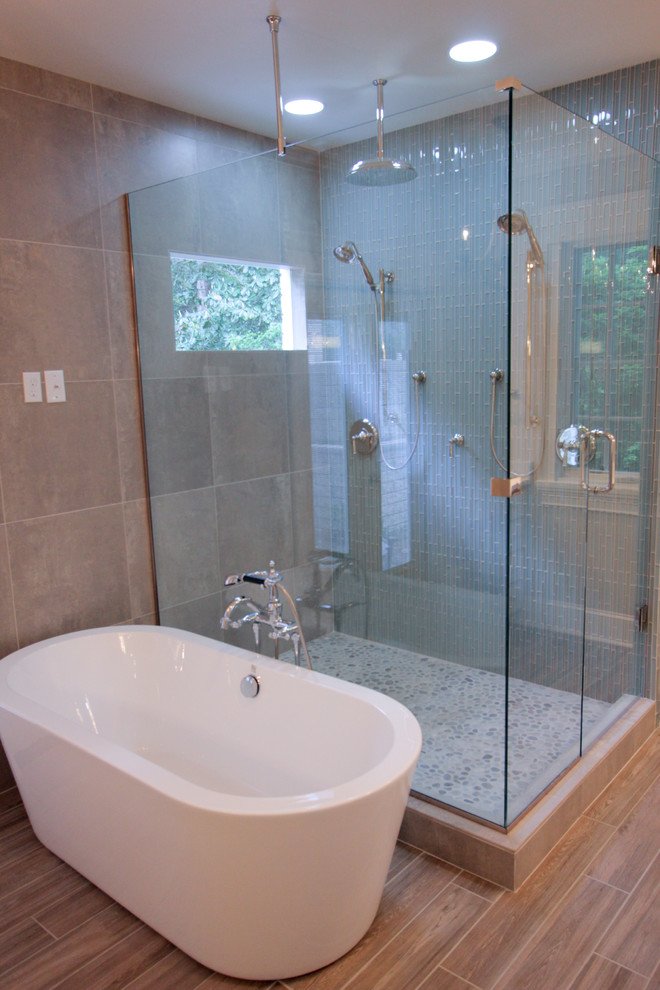 Immagine di una stanza da bagno padronale minimalista di medie dimensioni con lavabo sottopiano, ante lisce, ante beige, top in marmo, vasca freestanding, doccia ad angolo, piastrelle di vetro e pareti beige
