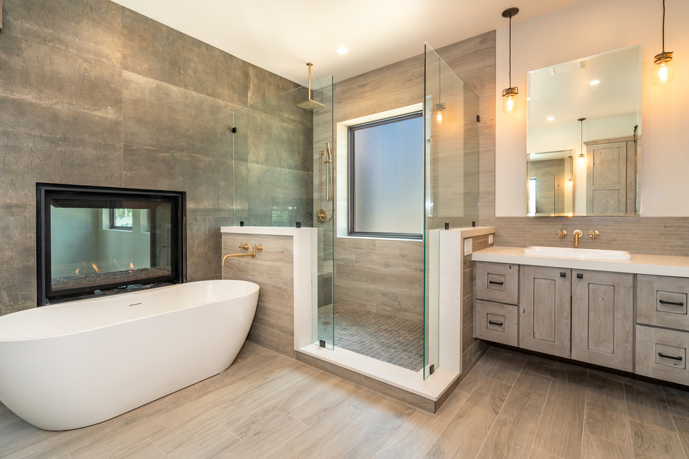 Example of a large trendy master gray tile and stone tile porcelain tile and beige floor bathroom design in Phoenix with shaker cabinets, light wood cabinets, white walls, a vessel sink, quartzite countertops and white countertops