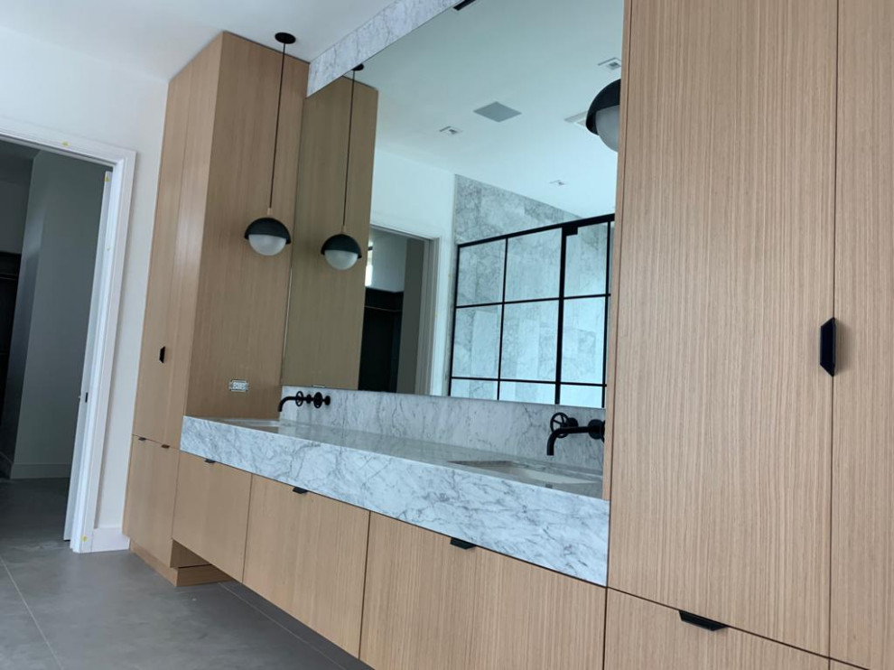 Huge minimalist master gray floor and double-sink walk-in shower photo in Miami with light wood cabinets, white walls, a hinged shower door and a floating vanity