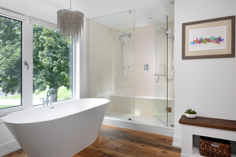 Example of a trendy master beige tile medium tone wood floor bathroom design in Toronto with white walls, flat-panel cabinets, white cabinets and a hinged shower door