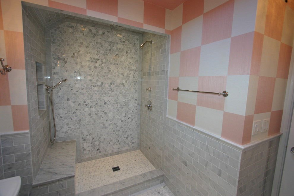 Photo of a medium sized eclectic shower room bathroom in Chicago with an alcove shower, grey tiles, stone tiles, marble flooring, louvered cabinets, grey cabinets, a two-piece toilet, pink walls, a submerged sink and marble worktops.