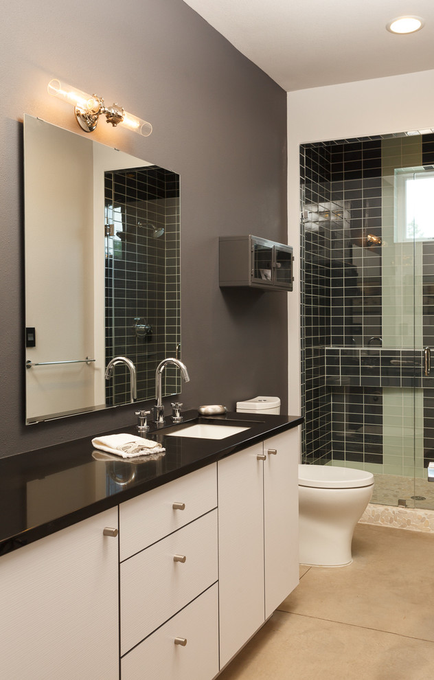 Example of an urban black tile and glass tile concrete floor bathroom design in Albuquerque with an undermount sink and gray walls