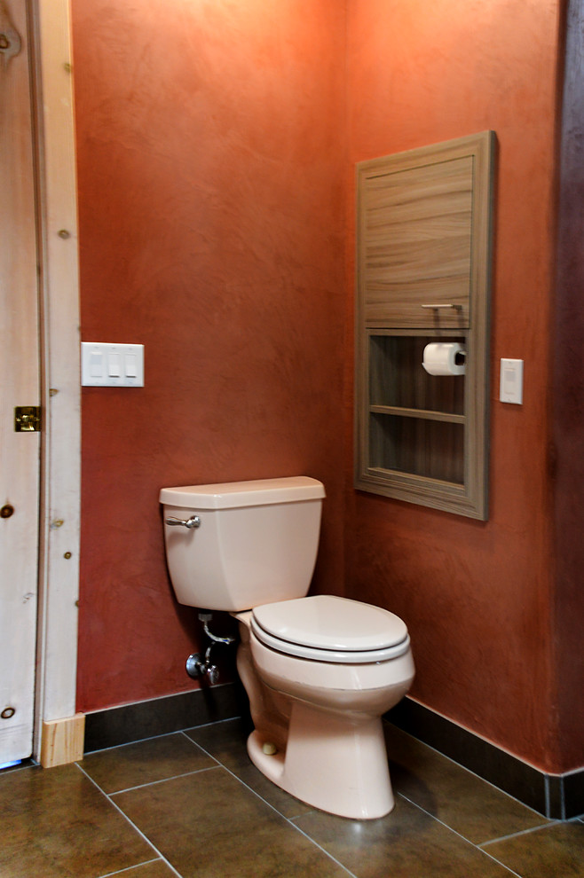Inspiration for a large modern cloakroom in Albuquerque with a built-in sink, flat-panel cabinets, medium wood cabinets, granite worktops, a two-piece toilet, brown tiles, glass tiles, orange walls and slate flooring.