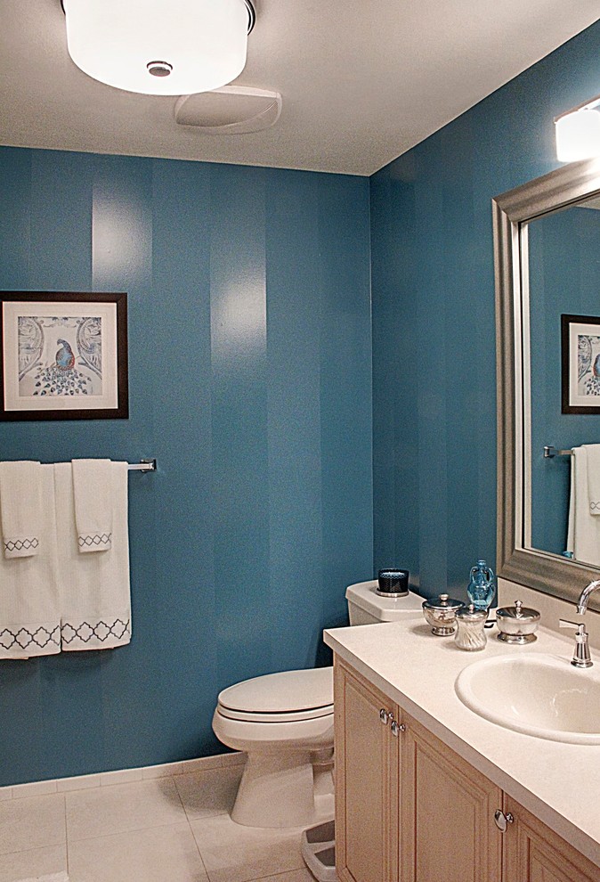 This is an example of a small traditional bathroom in New York with a built-in sink, beaded cabinets, light wood cabinets, laminate worktops, a two-piece toilet, blue walls and ceramic flooring.