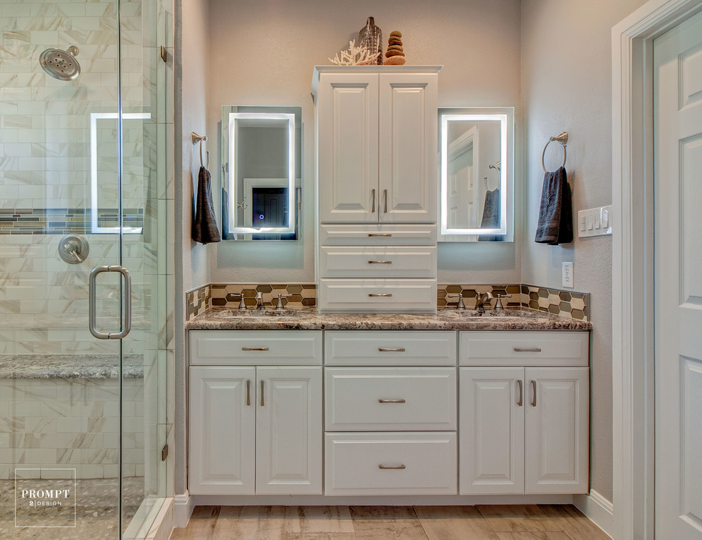 Example of a mid-sized transitional master white tile and porcelain tile porcelain tile double shower design in Austin with raised-panel cabinets, white cabinets, gray walls, an undermount sink and granite countertops