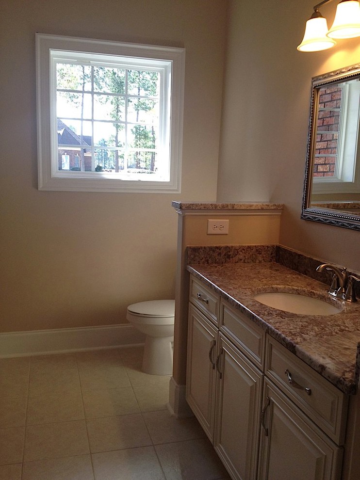 Medium sized traditional bathroom in Wilmington with raised-panel cabinets, beige cabinets, granite worktops, a walk-in shower, beige tiles, ceramic tiles, beige walls and ceramic flooring.