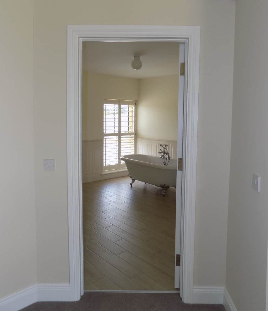 Large beach style family bathroom in Other with a freestanding bath, white walls, laminate floors and beige floors.