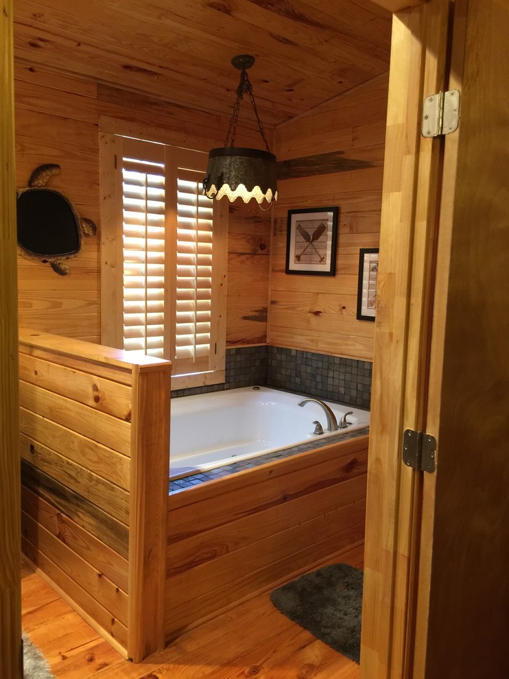 Idee per una stanza da bagno padronale country di medie dimensioni con ante in legno chiaro, vasca da incasso, piastrelle grigie, piastrelle in pietra e parquet chiaro