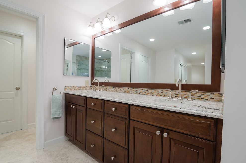 Example of a large eclectic master gray tile and stone tile marble floor and white floor bathroom design in DC Metro with an undermount sink, raised-panel cabinets, medium tone wood cabinets, granite countertops, a two-piece toilet, white walls and a hinged shower door
