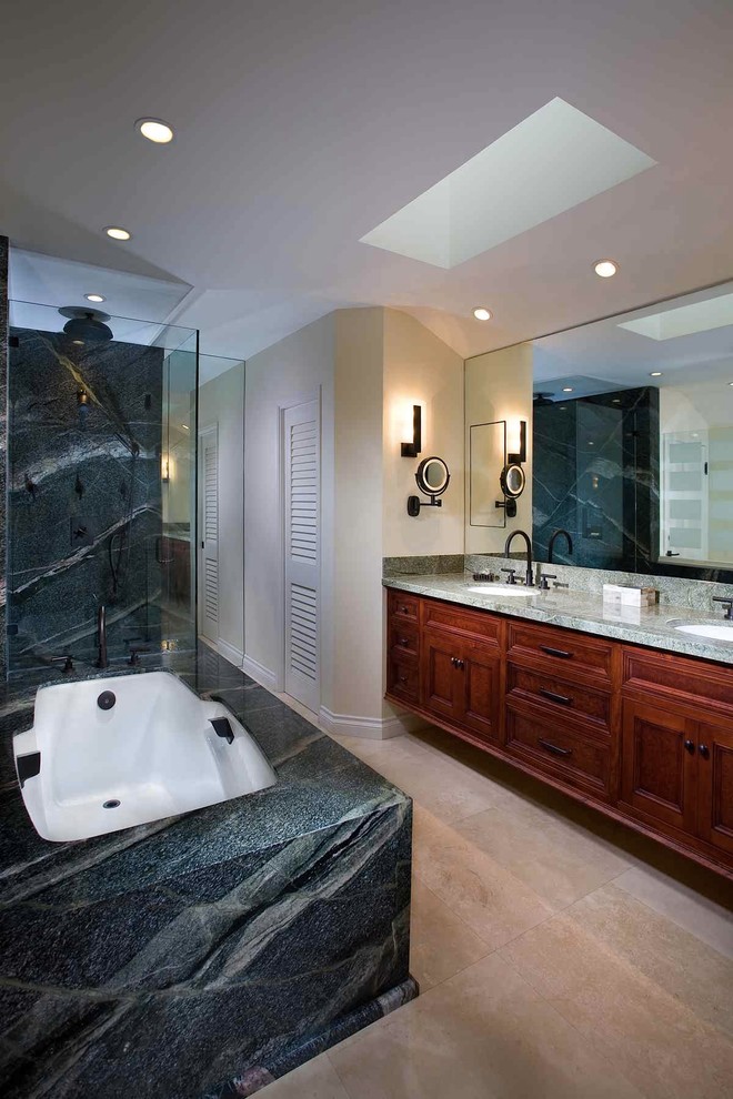 This is an example of a contemporary bathroom in Los Angeles with a submerged sink, recessed-panel cabinets, dark wood cabinets, a submerged bath, a corner shower and grey tiles.