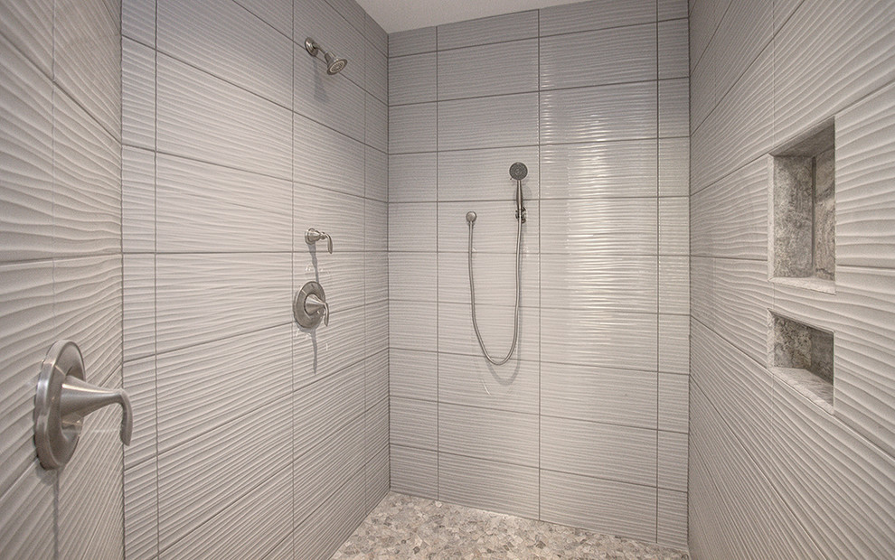 Medium sized contemporary ensuite bathroom in Charlotte with shaker cabinets, white cabinets, a freestanding bath, an alcove shower, a two-piece toilet, grey tiles, stone tiles, grey walls, ceramic flooring, a submerged sink and granite worktops.