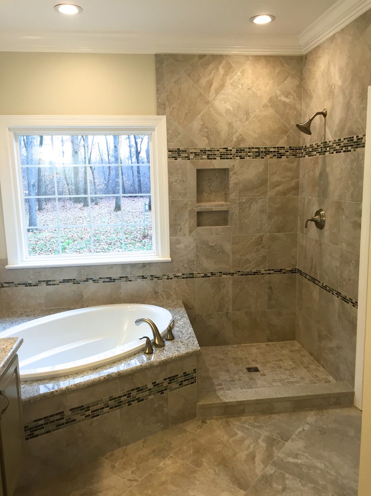 Photo of a medium sized classic ensuite bathroom in Other with a submerged sink, raised-panel cabinets, grey cabinets, granite worktops, a built-in bath, a corner shower, a two-piece toilet, grey tiles, porcelain tiles, grey walls and porcelain flooring.