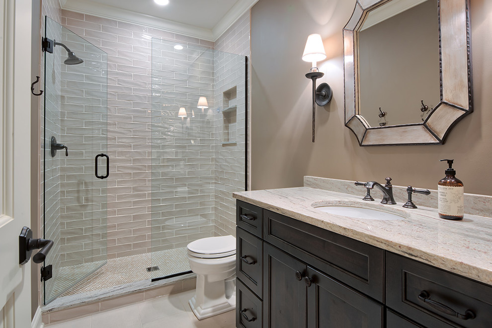 Inspiration for a timeless 3/4 bathroom remodel in Minneapolis with beaded inset cabinets, black cabinets, a one-piece toilet, beige walls, an undermount sink, marble countertops and a hinged shower door