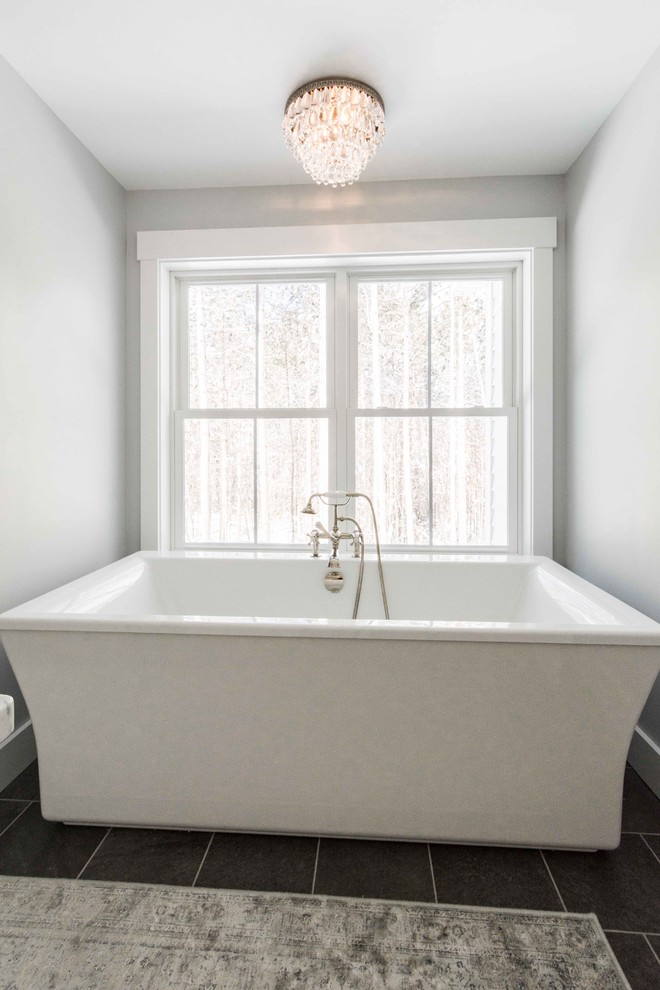 Medium sized classic ensuite bathroom in Portland Maine with shaker cabinets, white cabinets, a freestanding bath, a walk-in shower, white tiles, metro tiles, grey walls, slate flooring, marble worktops, grey floors and a hinged door.