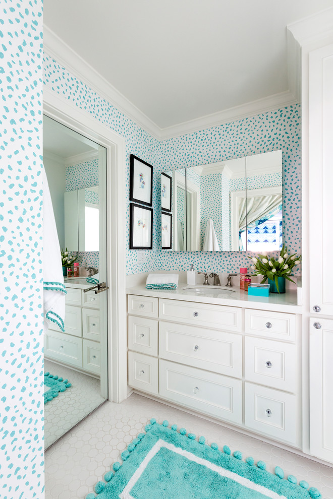 Klassisk inredning av ett vit vitt badrum för barn, med luckor med infälld panel, vita skåp, klinkergolv i keramik, ett undermonterad handfat, blå väggar och vitt golv