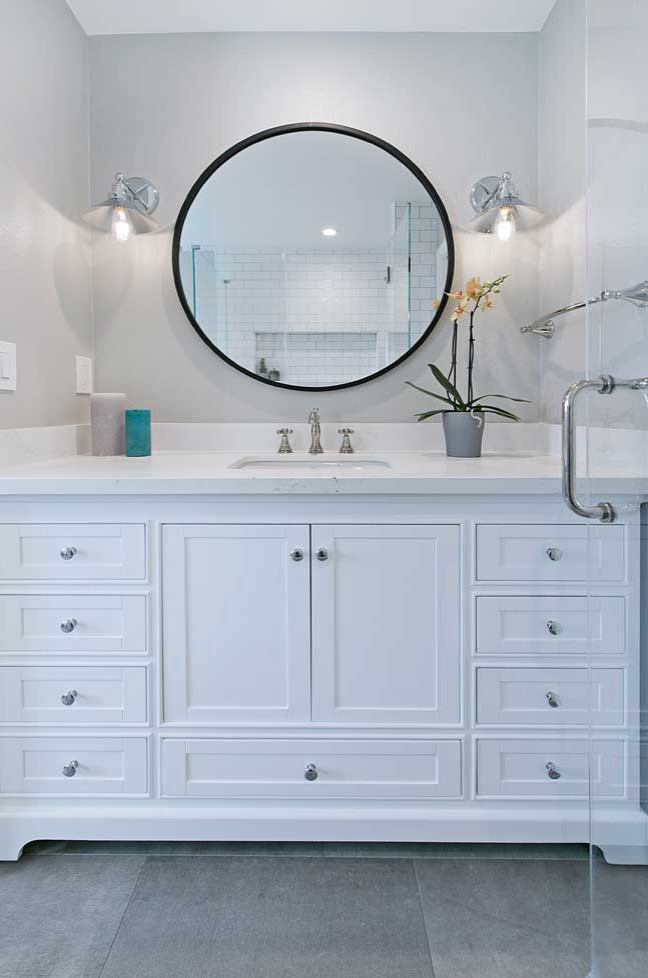 Example of a mid-sized transitional master white tile and subway tile porcelain tile, gray floor and single-sink bathroom design in San Francisco with furniture-like cabinets, white cabinets, a two-piece toilet, gray walls, an undermount sink, quartz countertops, a hinged shower door, white countertops and a freestanding vanity