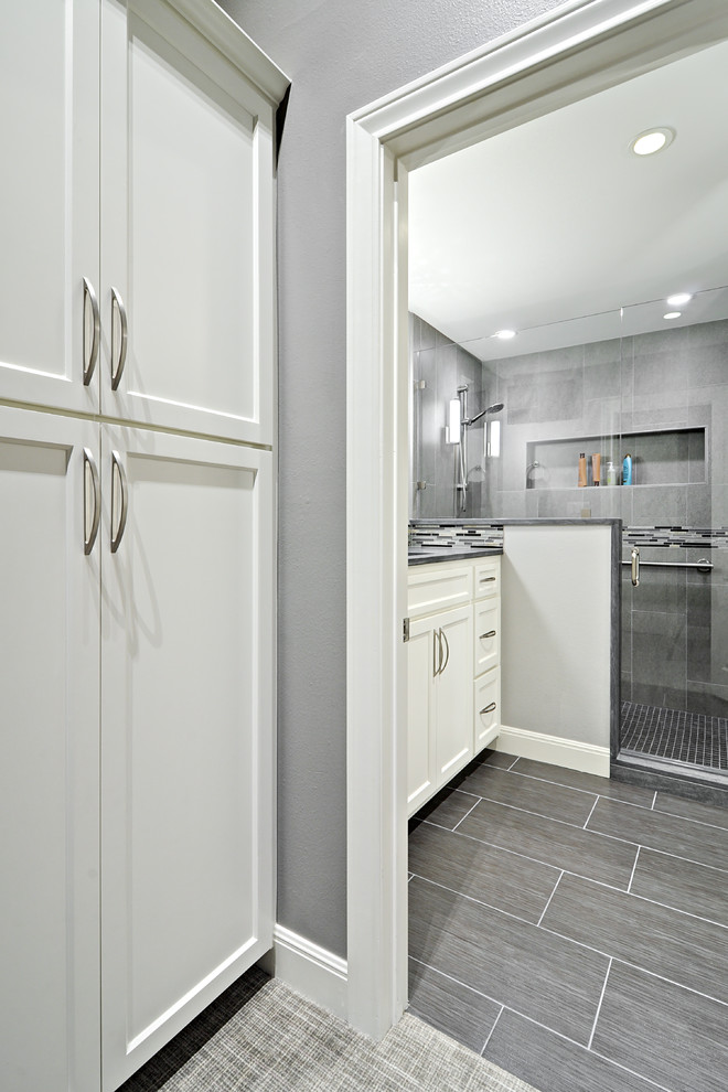 Inspiration for a small transitional gray tile and ceramic tile porcelain tile corner shower remodel in Austin with an undermount sink, raised-panel cabinets, white cabinets, quartzite countertops and gray walls