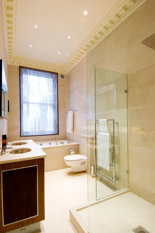 Foto de cuarto de baño minimalista de tamaño medio con bañera esquinera, ducha abierta, sanitario de pared, baldosas y/o azulejos beige, paredes beige y lavabo encastrado