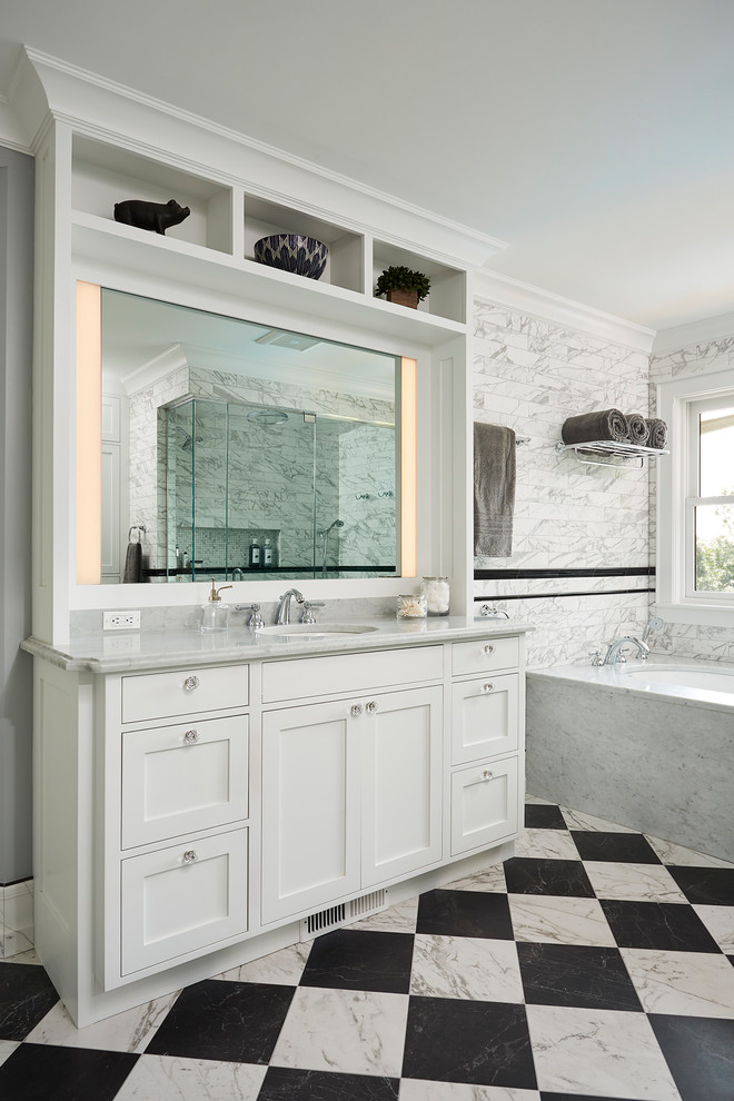 Inspiration for a large transitional master black and white tile and porcelain tile porcelain tile walk-in shower remodel in Minneapolis with recessed-panel cabinets, white cabinets, an undermount tub, gray walls, an undermount sink, marble countertops and a hinged shower door