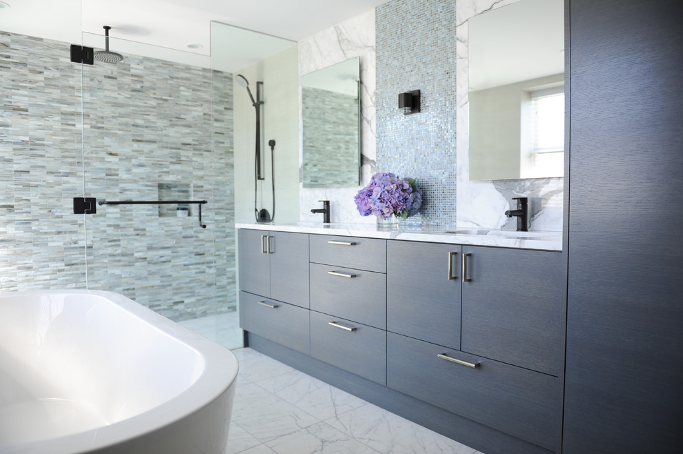 Example of a mid-sized trendy master blue tile and glass sheet marble floor bathroom design in Vancouver with flat-panel cabinets, dark wood cabinets, marble countertops, a wall-mount toilet, beige walls and an undermount sink