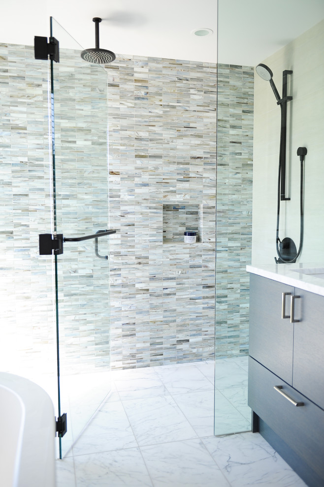 Bathroom - mid-sized contemporary master blue tile and glass sheet marble floor bathroom idea in Vancouver with flat-panel cabinets, dark wood cabinets, a wall-mount toilet, beige walls, an undermount sink and marble countertops