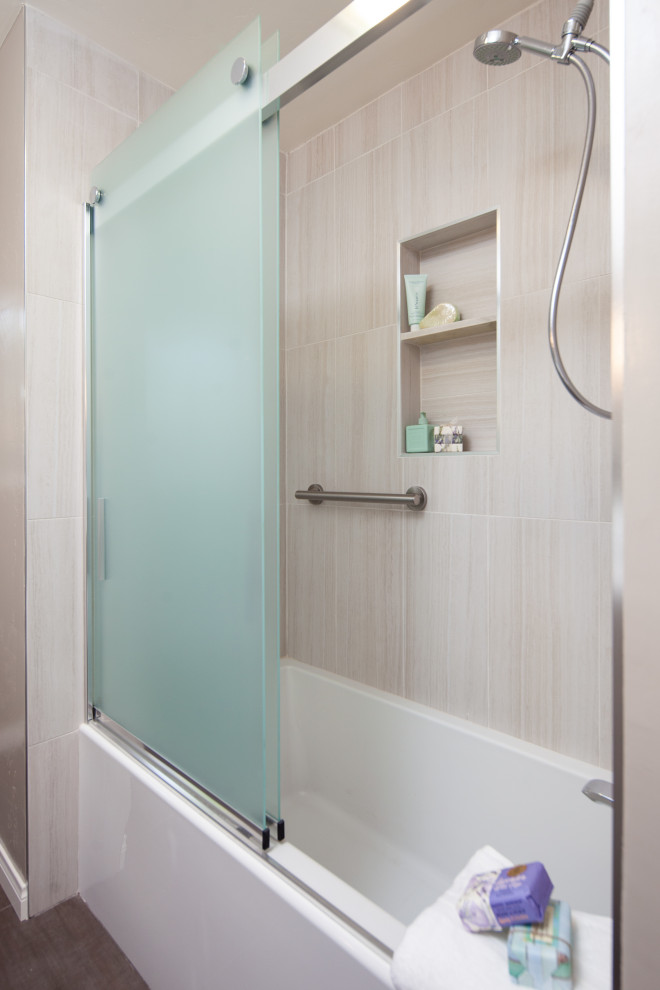 Inspiration for a medium sized modern ensuite bathroom in San Diego with a shower/bath combination, a two-piece toilet, beige tiles, beige walls, a submerged sink, a sliding door, flat-panel cabinets, grey cabinets, travertine tiles, porcelain flooring, engineered stone worktops, grey floors and multi-coloured worktops.